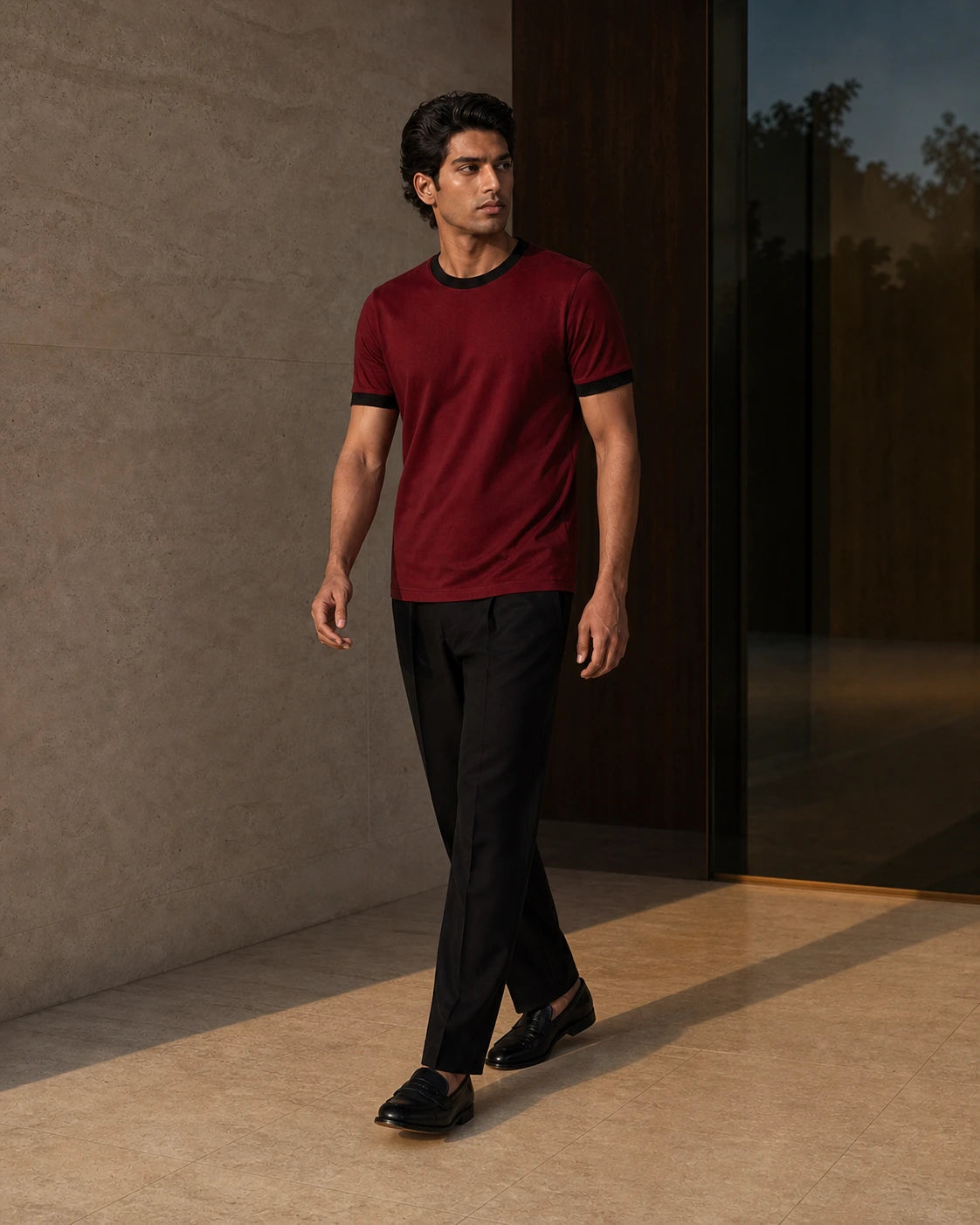 DARENZ First Line Ringer Tee in Cardinal / Black shown in motion beside dark timber, with the garment drape clearly visible