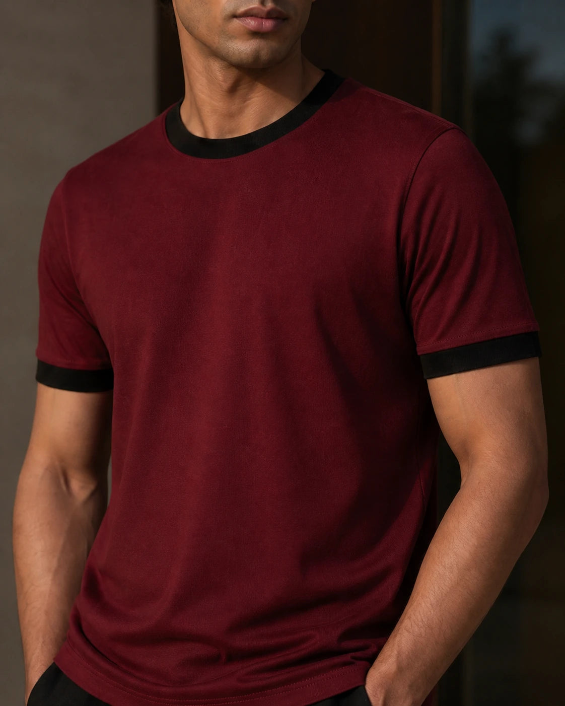 Close-up of the DARENZ First Line Ringer Tee in Cardinal / Black, showing the black ribbed collar, sleeve cuffs and natural cotton-jersey texture