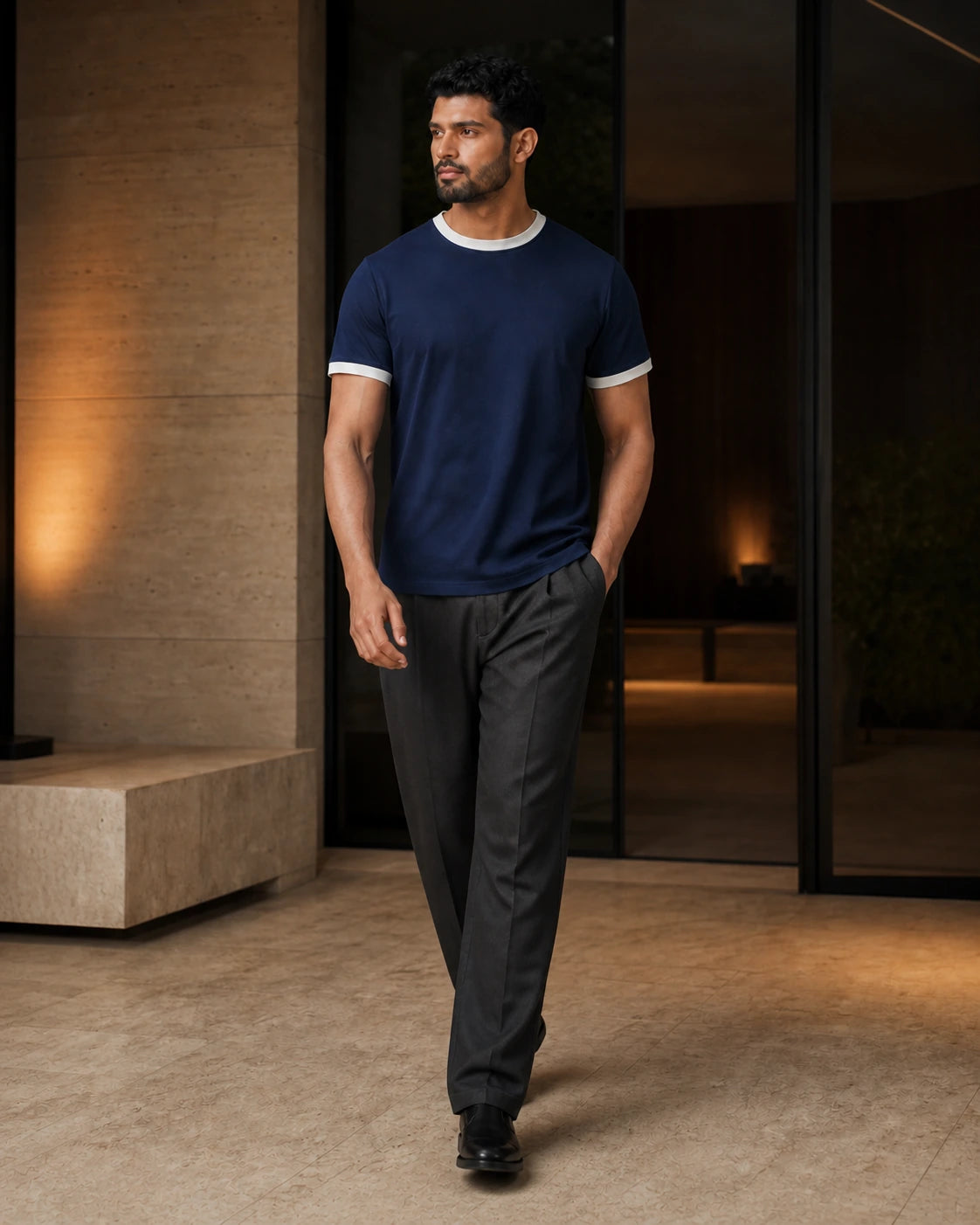 DARENZ First Line Ringer Tee in Midnight / Chalk shown in motion beside dark timber, with the garment drape clearly visible