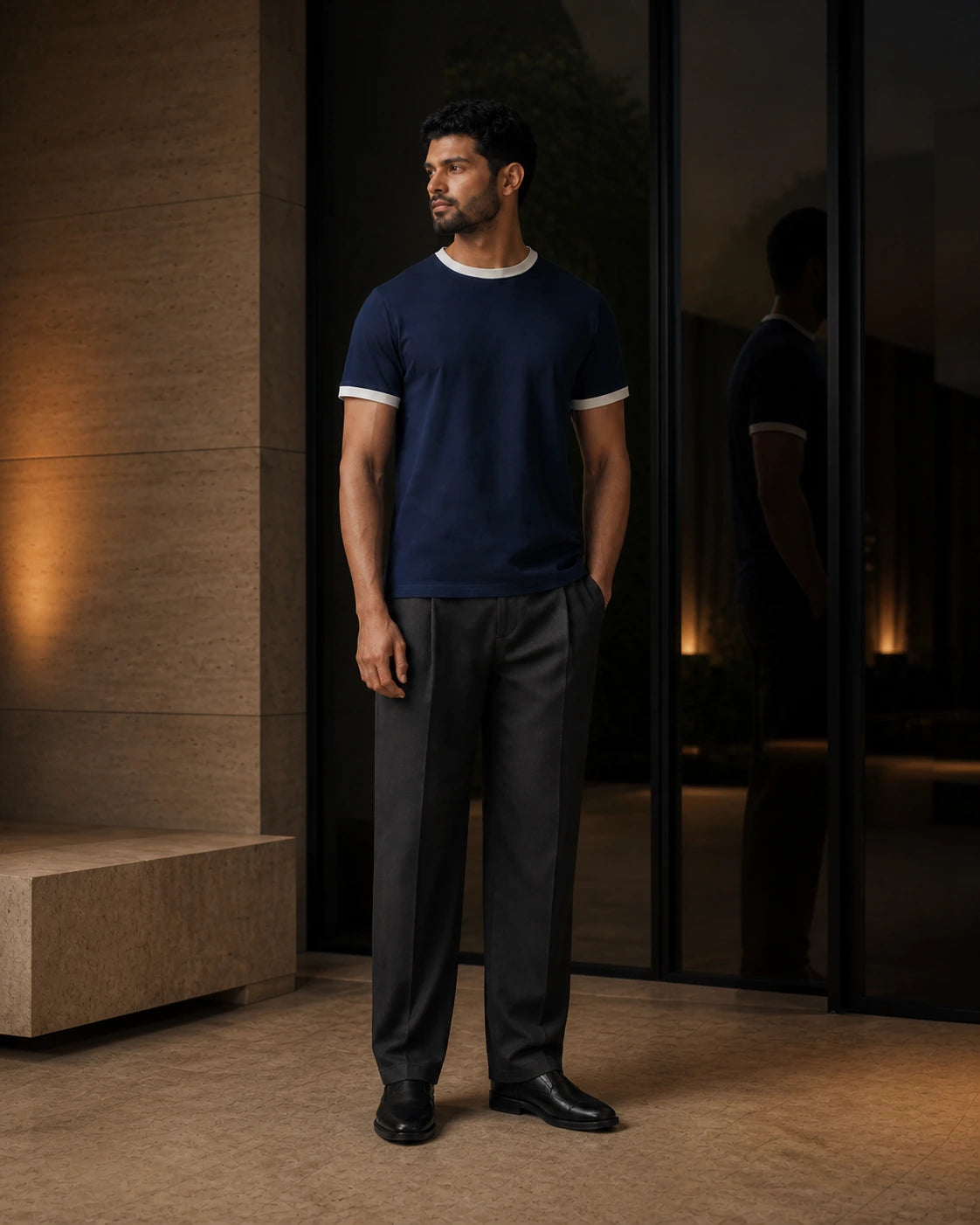 Between Lines chapter portrait featuring the Midnight / Chalk DARENZ First Line Ringer Tee in a charcoal evening interior