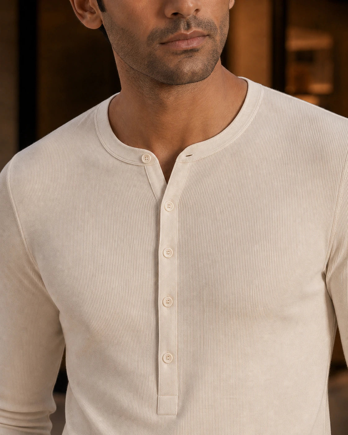 Close-up of the DARENZ Interval Long-Sleeve Henley in Ivory, showing the ivory rib texture, round neckline and aligned five-button placket
