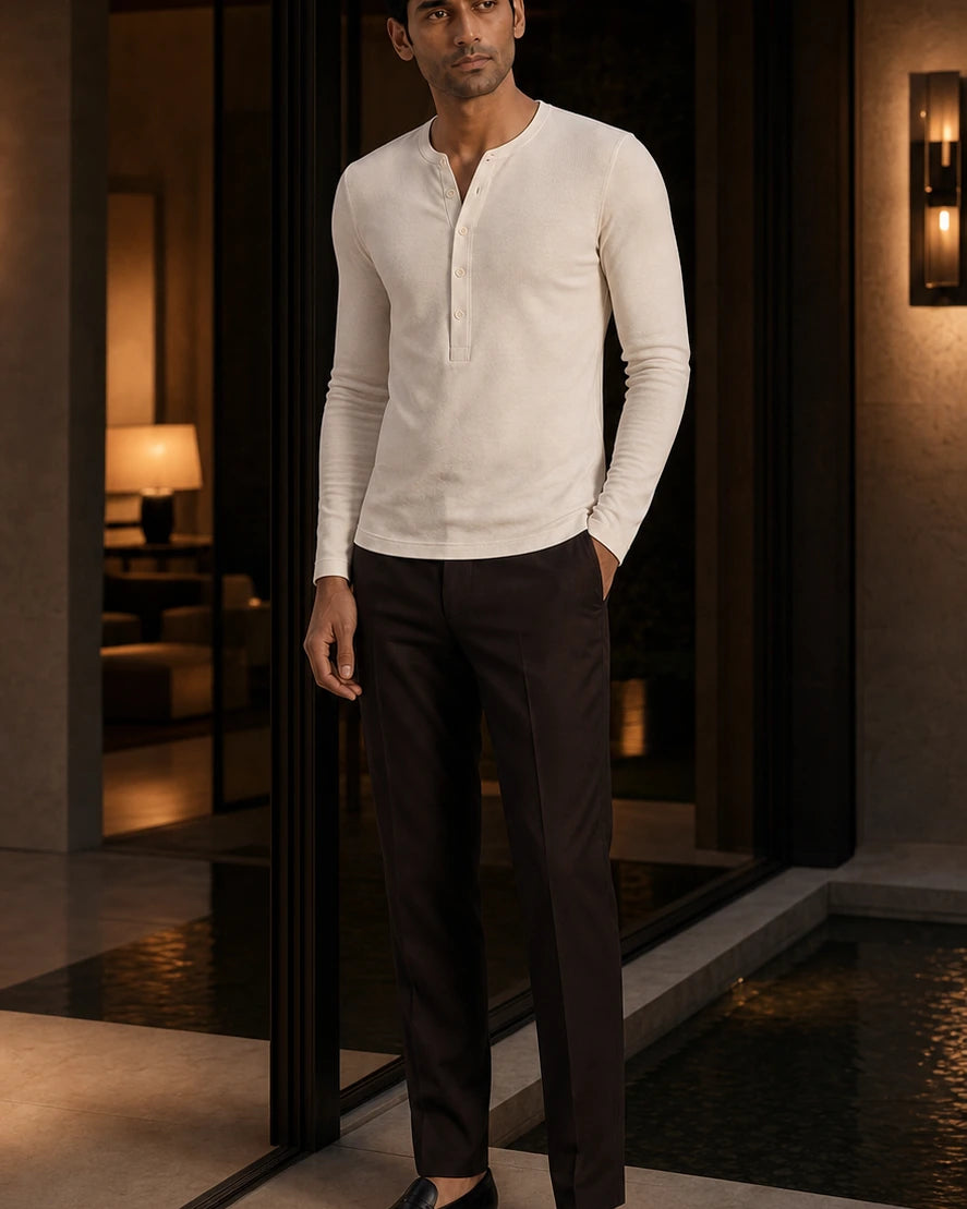 Between Lines chapter portrait featuring the Ivory DARENZ Interval Long-Sleeve Henley in a charcoal evening interior