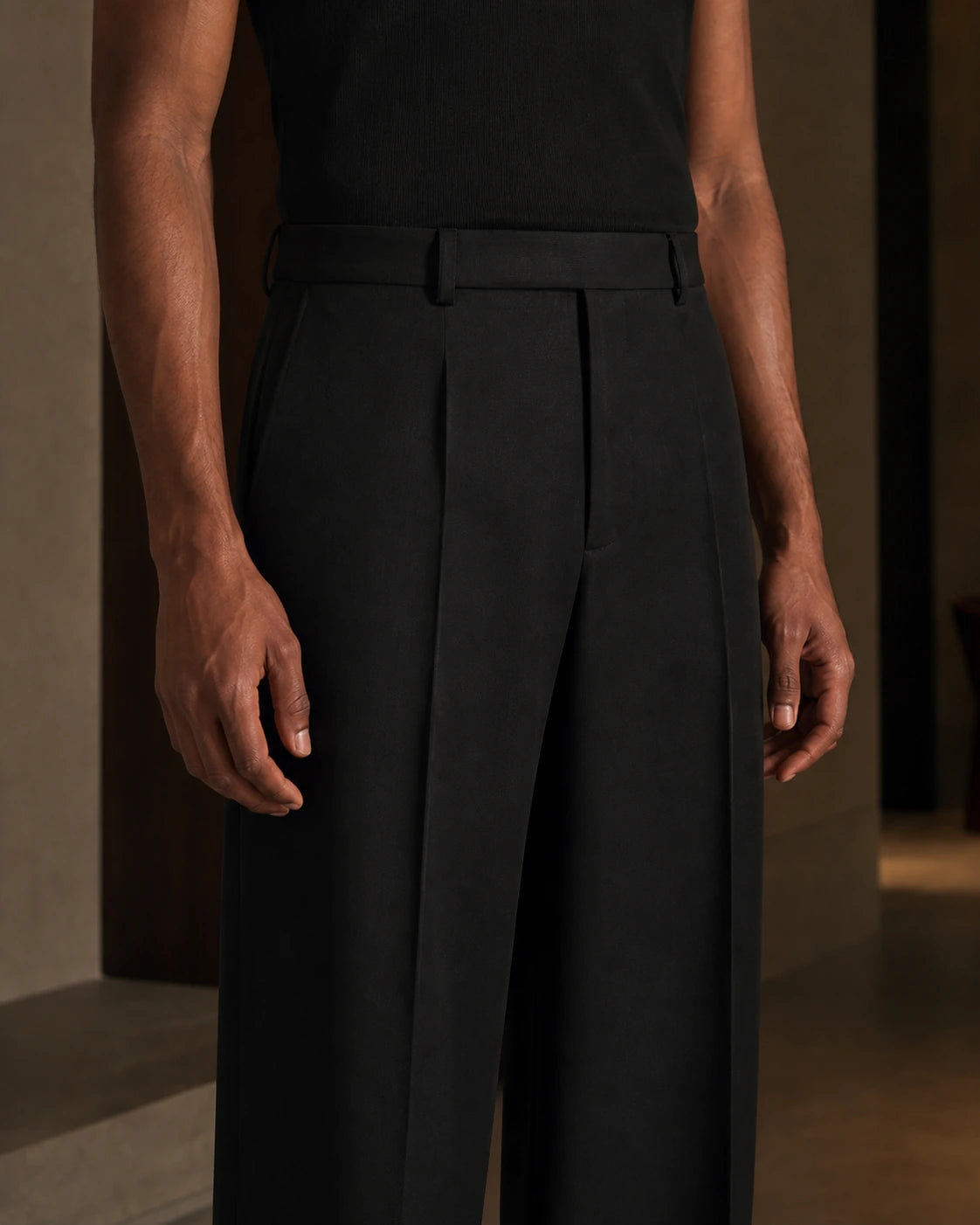 Close-up of the DARENZ Long Form Loose Tailored Trousers in Ink, showing the pressed front crease, twill weave and concealed waistband fastening