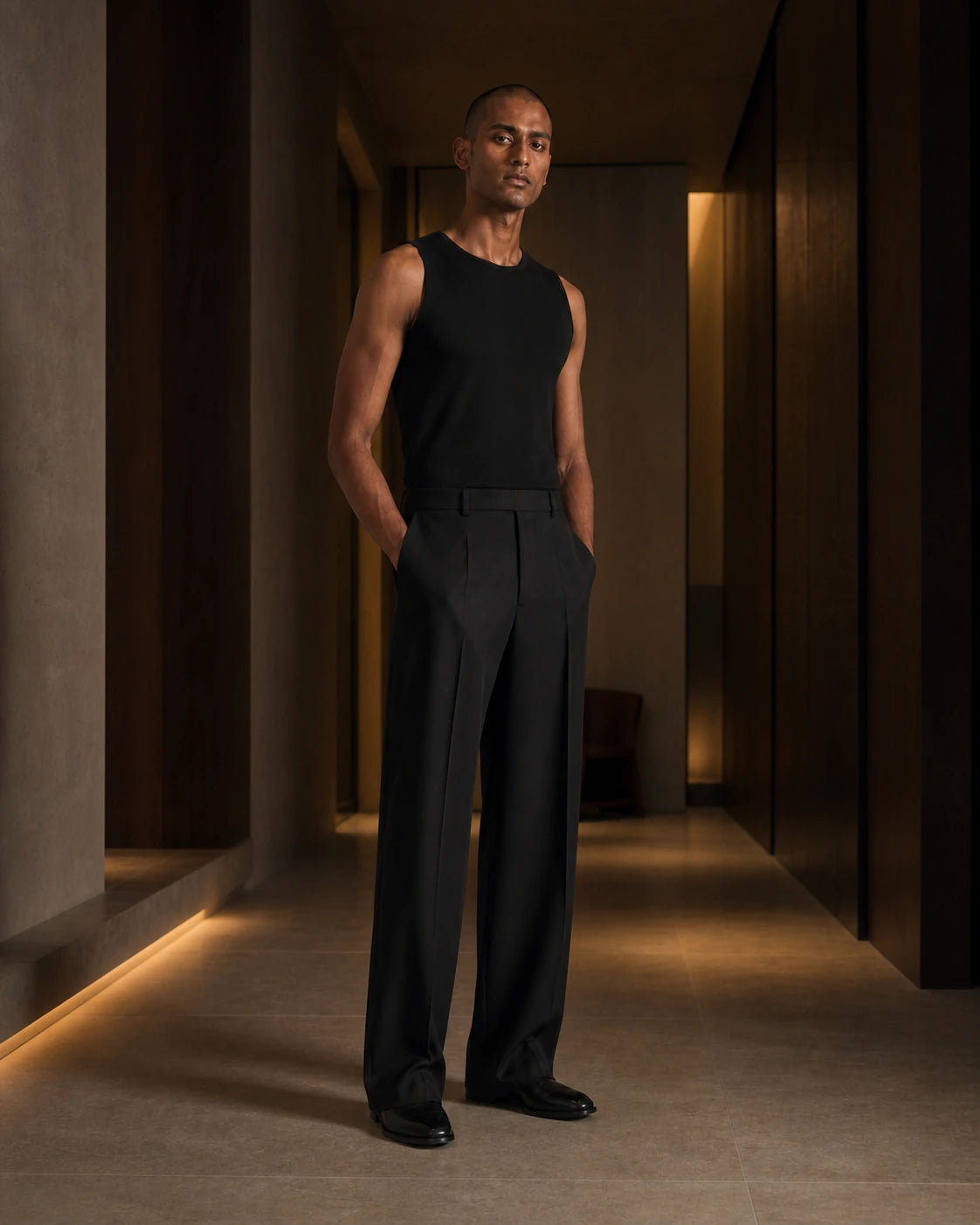 Between Lines chapter portrait featuring the Ink DARENZ Long Form Loose Tailored Trousers in a charcoal evening interior