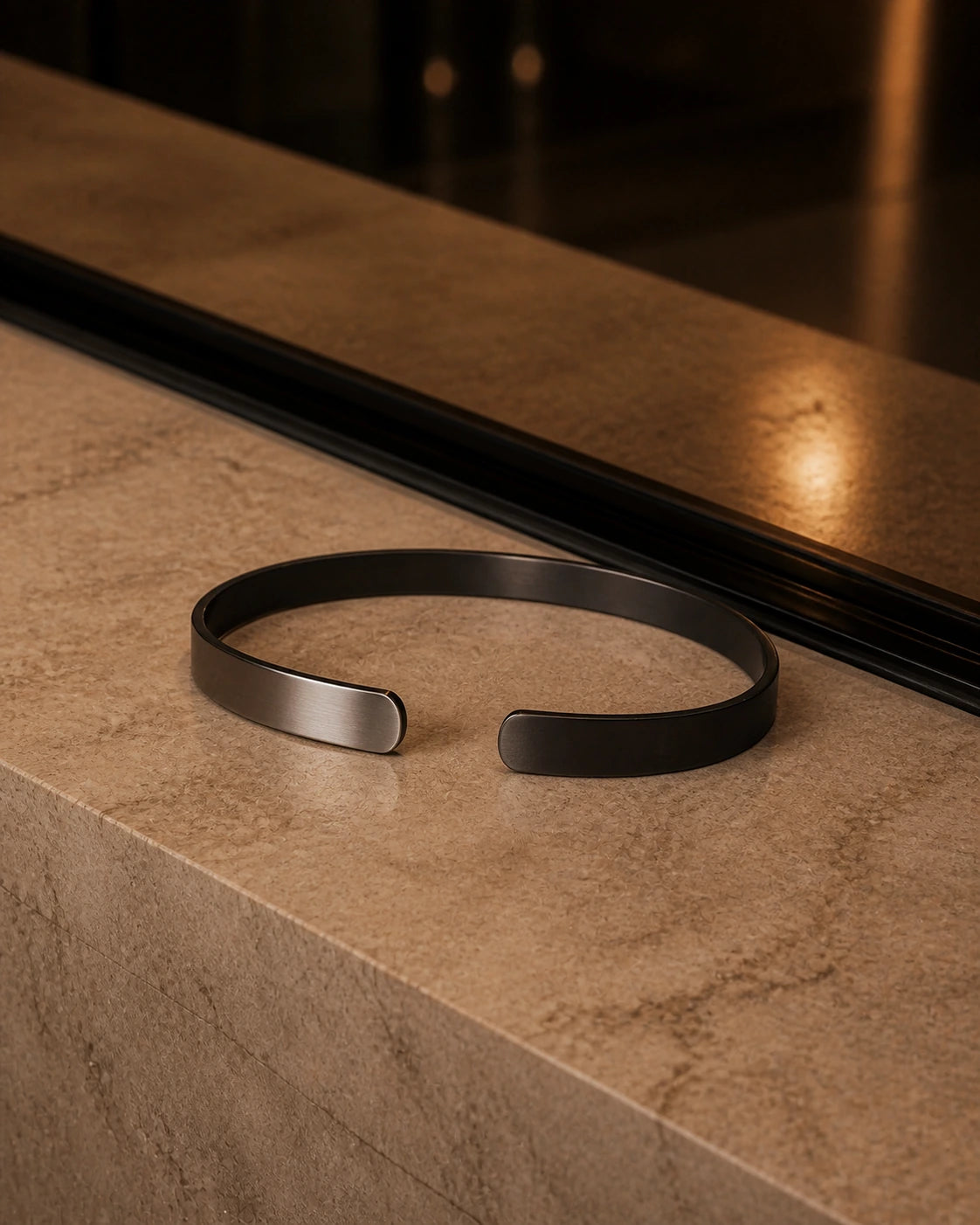 DARENZ Parenthesis Cuff still life on charcoal stone with dark timber and controlled evening light