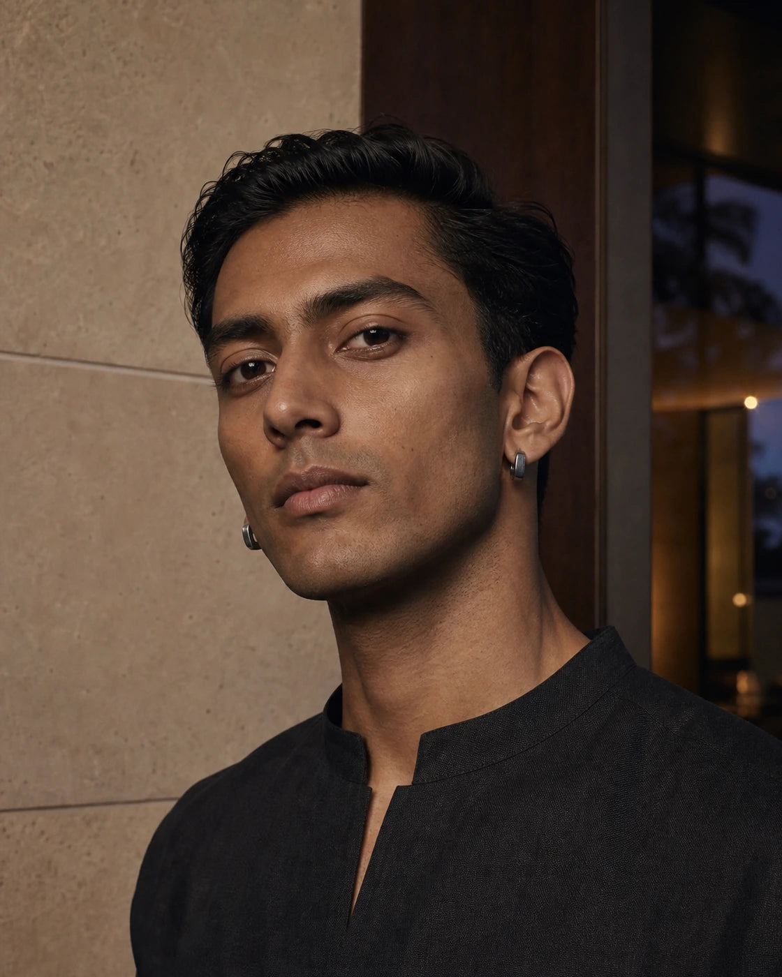 South Asian male model wearing the matched DARENZ Quote Hoop Pair in gunmetal steel at the Between Lines residence