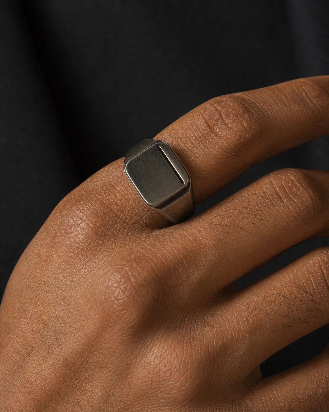 Macro photograph of the DARENZ Seal Ring, revealing the brushed signet face, blackened recessed field and open shank