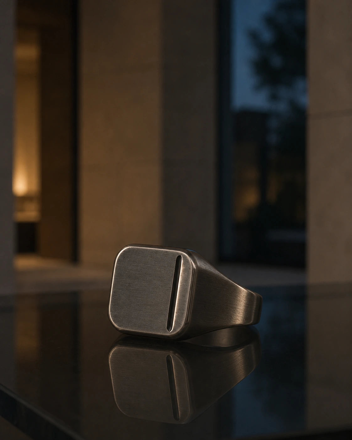 DARENZ Seal Ring still life on charcoal stone with dark timber and controlled evening light