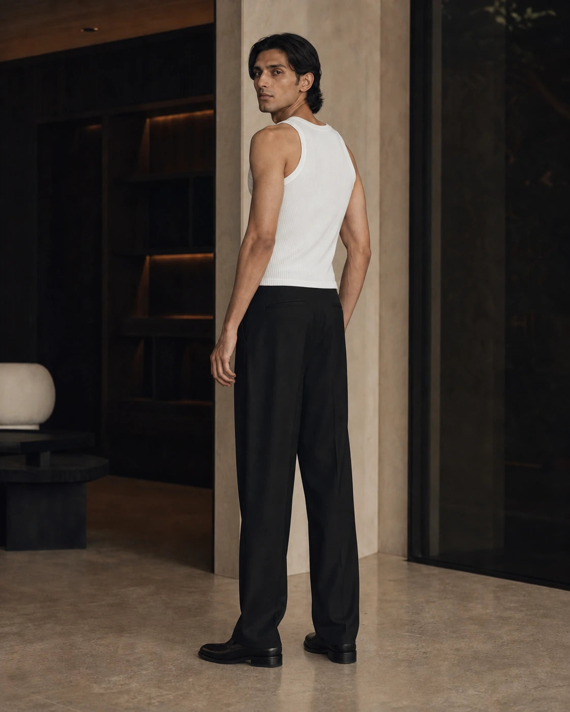 Side and back view of the Chalk DARENZ Underline Ribbed Vest on its assigned model near smoked glass